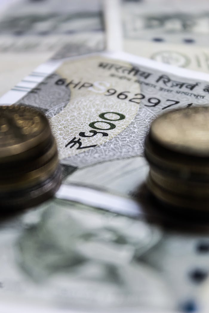 ours-journey Macro view of Indian currency featuring rupees and coins, showcasing financial abundance.